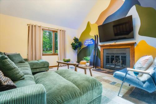 a living room with a couch and a fireplace at Game Room Hot Tub Mins to Slopes Fire Pit in McGaheysville