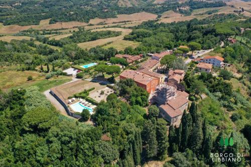 an aerial view of a house with a pool at Borgo di Libbiano - for exploring all of Tuscany in Libbiano