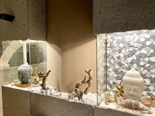 a window display with a statue and other items on display at Sebastian's Elegant Apartment in Aci Castello