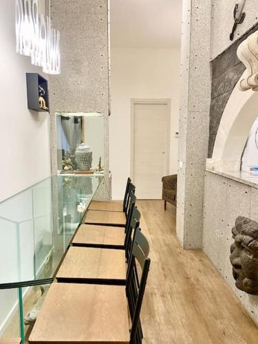 a room with a table and chairs in a store at Sebastian's Elegant Apartment in Aci Castello