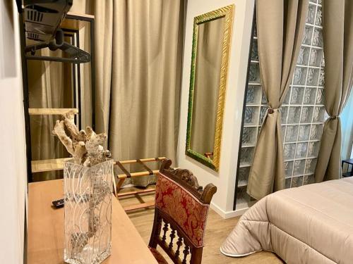 a bedroom with a bed and a table and a chair at Sebastian's Elegant Apartment in Aci Castello