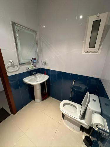 a bathroom with a toilet and a sink at complexe al massira imm 13 n 6 etg 2 in Fnidek