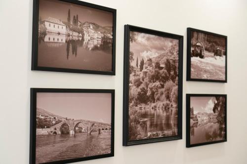 a group of pictures hanging on a wall at Apartman Pike centar in Trebinje