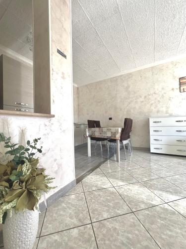a dining room with a table and chairs in a room at SEA apartment in Fiumicino