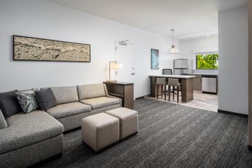 a living room with a couch and a table at Hyatt House Naples 5th Avenue in Naples
