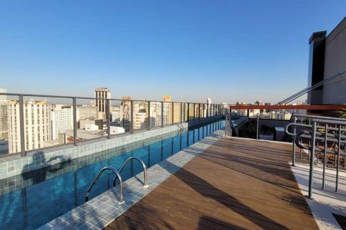 a swimming pool on the roof of a building at Studio Novo Alto Padrão - Centro in Curitiba