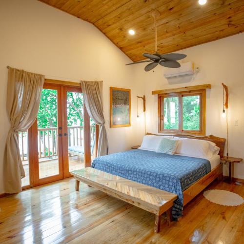a bedroom with a bed and a wooden ceiling at Casa Cayuco Eco-Adventure Lodge in Bocas del Toro