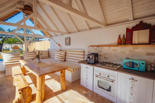 a kitchen with a wooden table and a stove at Casa Ilinca in Jurilovca