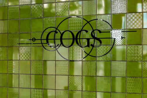 a tile wall with the word cough written on it at Hotel Indigo Coventry by IHG in Coventry