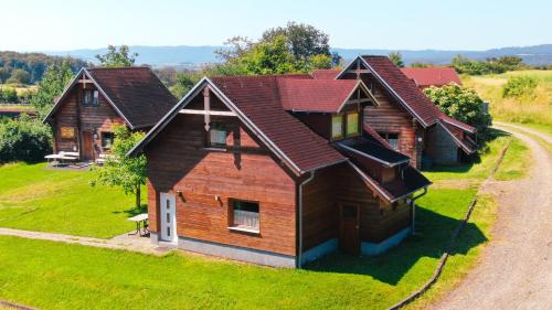 a wooden house on a grassy field with a road at Ferienwohnung Burg Katz in Lahnstein