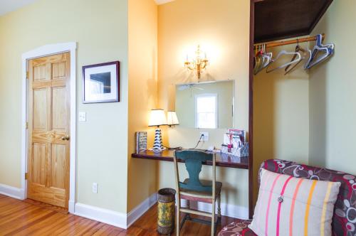 a room with a desk with a chair and a mirror at Cozy Missouri Retreat with Pool, Pond and Fire Pit! in Berger