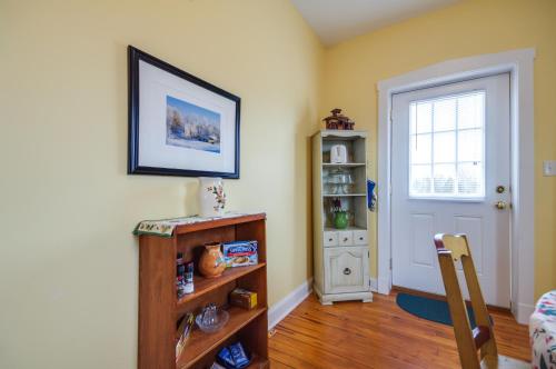 a room with a door and a table and a chair at Cozy Missouri Retreat with Pool, Pond and Fire Pit! in Berger