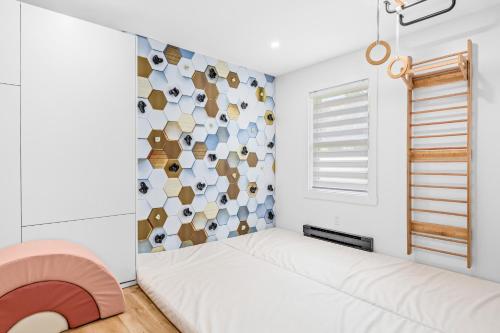 a bedroom with a bed and a wall of cups at Les Petits Chalets in Val-des-Lacs