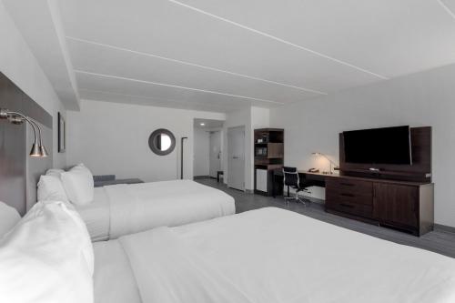 a hotel room with two beds and a flat screen tv at Comfort Suites Mt Juliet-Nashville Area in Mount Juliet
