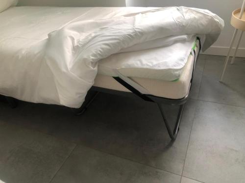 a bed with a white comforter on top of it at Veniero37 Guest House in Rome