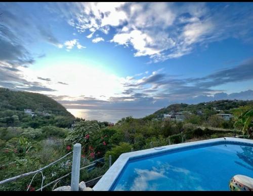 a swimming pool on the balcony of a house at Casa Macondo in Puerto Ángel