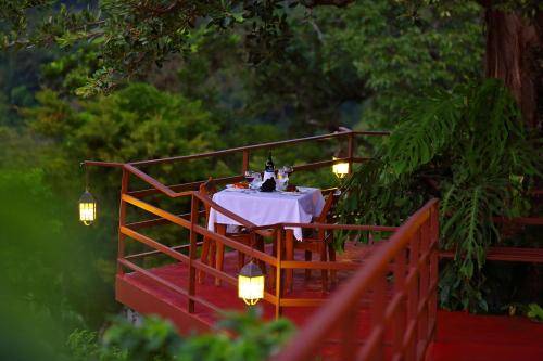 a table with bottles of wine sitting on a red fence at Los Establos Boutique Resort - All Inclusive in Boquete