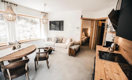 a living room with a table and a couch at Chalet Sonnstein in Mieders