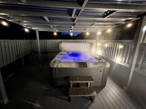 a room with a bed with a bench in it at Numero Venti Aparthouse wifi parking Hot Tub in Newcastle upon Tyne