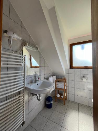 a white bathroom with a sink and a window at Ferienwohnung Burg Maus in Lahnstein