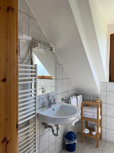 a bathroom with a sink in a attic at Ferienwohnung Burg Maus in Lahnstein