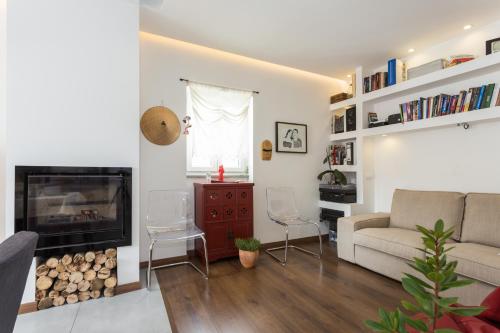 a living room with a couch and a fireplace at Casas da Formosa - Downtown Alegria B&B in Tavira