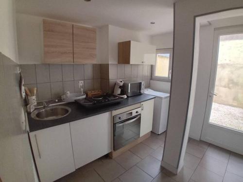 a kitchen with a sink and a counter top at Maison à Eu proche centre ville et baie de Somme in Eu