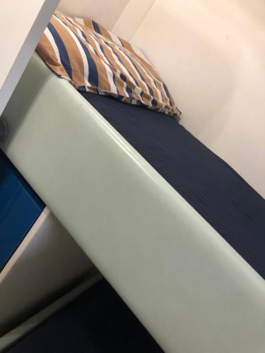 a bed with a tie on top of it at Miss Mary in Porto Santa Margherita di Caorle