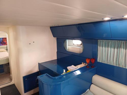 a small room with blue walls and a blue shelf at Miss Mary in Porto Santa Margherita di Caorle