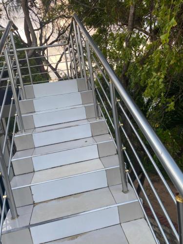 a set of stairs with a metal railing at RoundHouse in Mombasa
