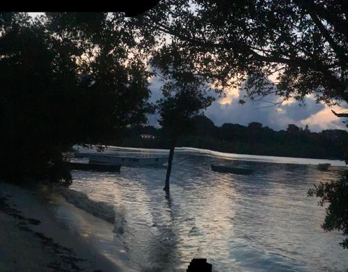a river with two boats in the water at RoundHouse in Mombasa