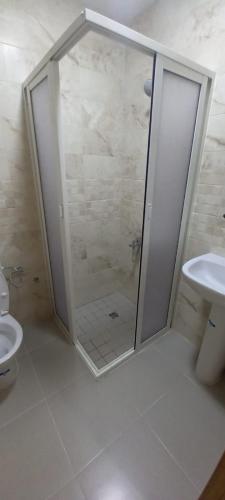 a bathroom with a shower and a toilet at Yaacob & Adam apartment Riad Sofia Martil in Martil