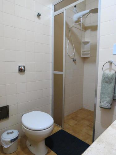 a bathroom with a toilet and a shower at Bertioga Beach Hostel in Bertioga