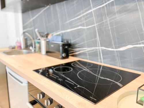 a kitchen with a sink and a counter top at Le petit loft in Brest