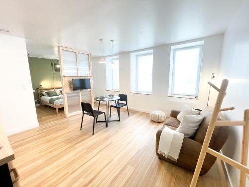 a living room with a couch and a table at Le petit loft in Brest