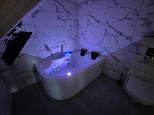 a bathroom with a tub with a purple lighting at Apartament z prywatna wanną hydromasaż - U Parów in Białka Tatrzanska