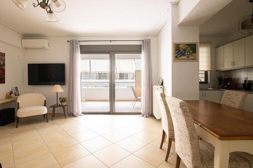 a kitchen and dining room with a table and chairs at Elegant Apt 50meters Close Acropolis in Athens
