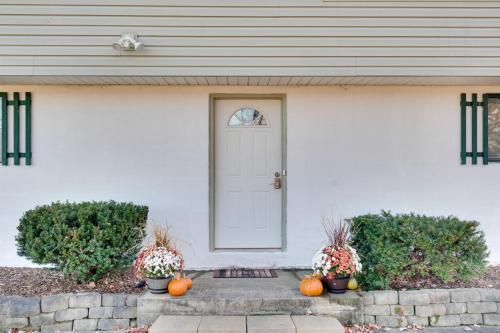 a white house with pumpkins and a door at Peaceful Horseheads Hideaway with Deck and Yard! in Horseheads