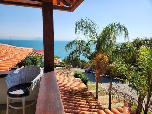 a view of the ocean from a house balcony at Pousada Dreamland Buzios in Búzios