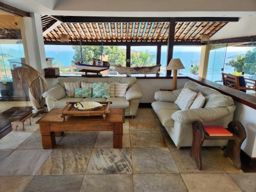 a living room with a couch and a coffee table at Pousada Dreamland Buzios in Búzios