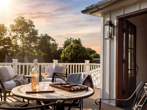 a patio with a table and chairs on a balcony at 1313 West Luxury Boutique Hotel in Annapolis