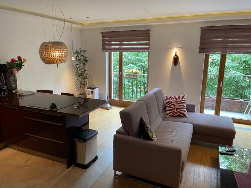 a living room with a couch and a table at ComeWa Apartments in Warsaw