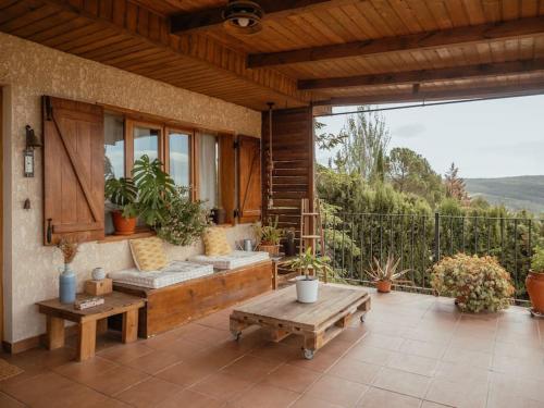 a patio with benches and tables on a house at Casa Marla, Siete Aguas in Siete Aguas