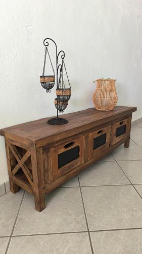 a wooden coffee table with two baskets on top at Villa Orizontes in Spetses