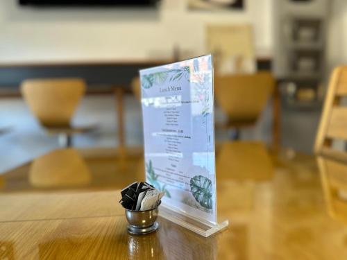 a sign on top of a table with a small cup at OYO The Bentleys Hotel in Newcastle upon Tyne