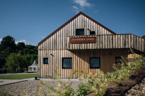 a barn with a sign on the side of it at Štajerska sivka - Jacuzzi & Savna in Maribor