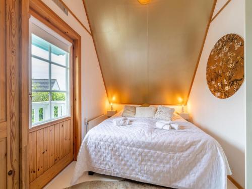 a bedroom with a bed and a window at Holiday Home by Zuidlaardermeer with Jetty in Groningen