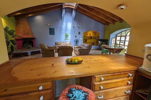a living room with a table with a bowl of fruit at Chalet La Llovizna - Lush hidden paradise in Panajachel in Panajachel