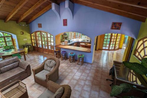 a large living room with a couch and a kitchen at Chalet La Llovizna - Lush hidden paradise in Panajachel in Panajachel