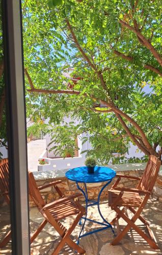 a blue table and two chairs on a patio at Giannakis Filoxenia in Philotium